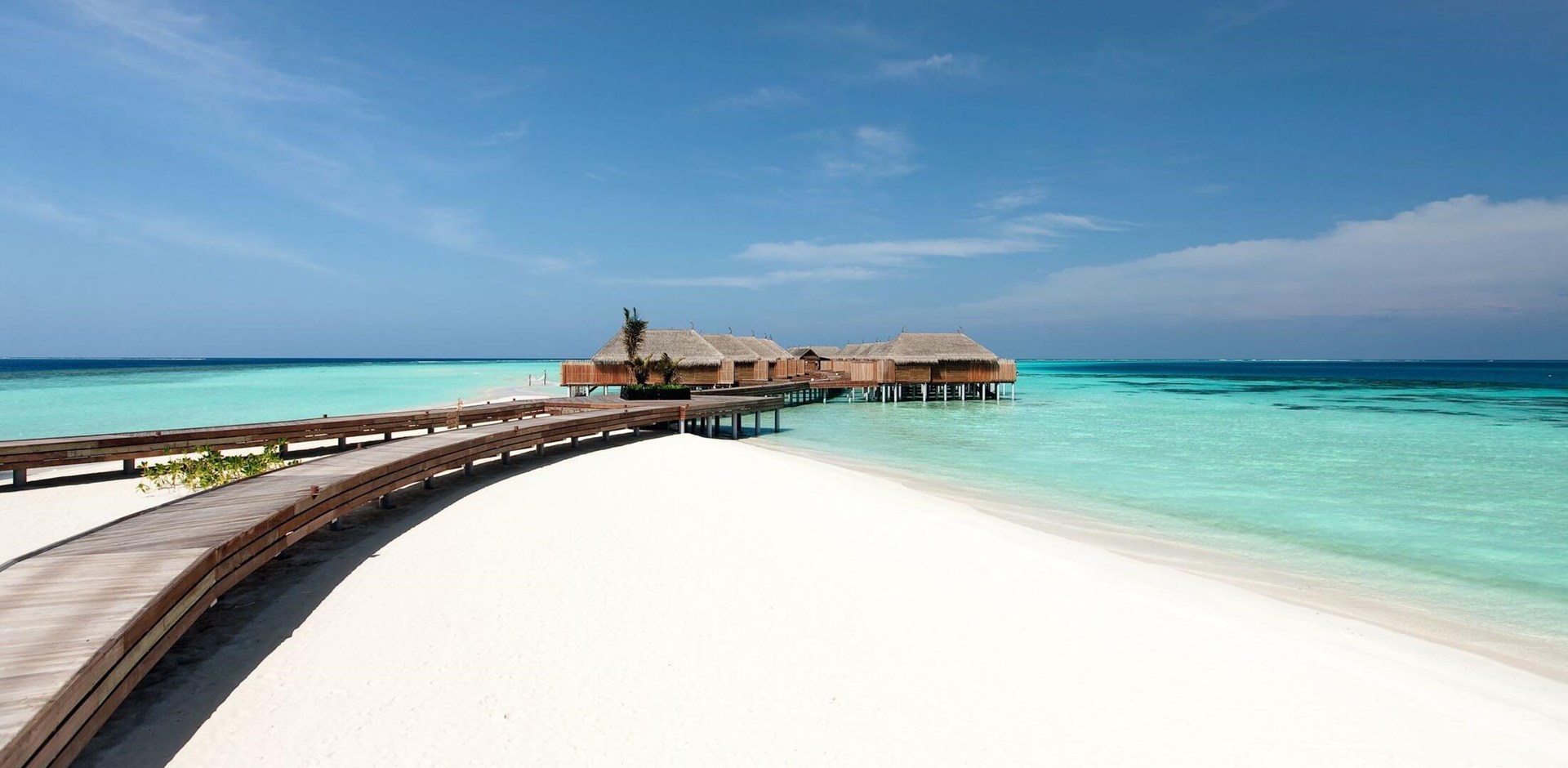 a sandy beach next to a body of water